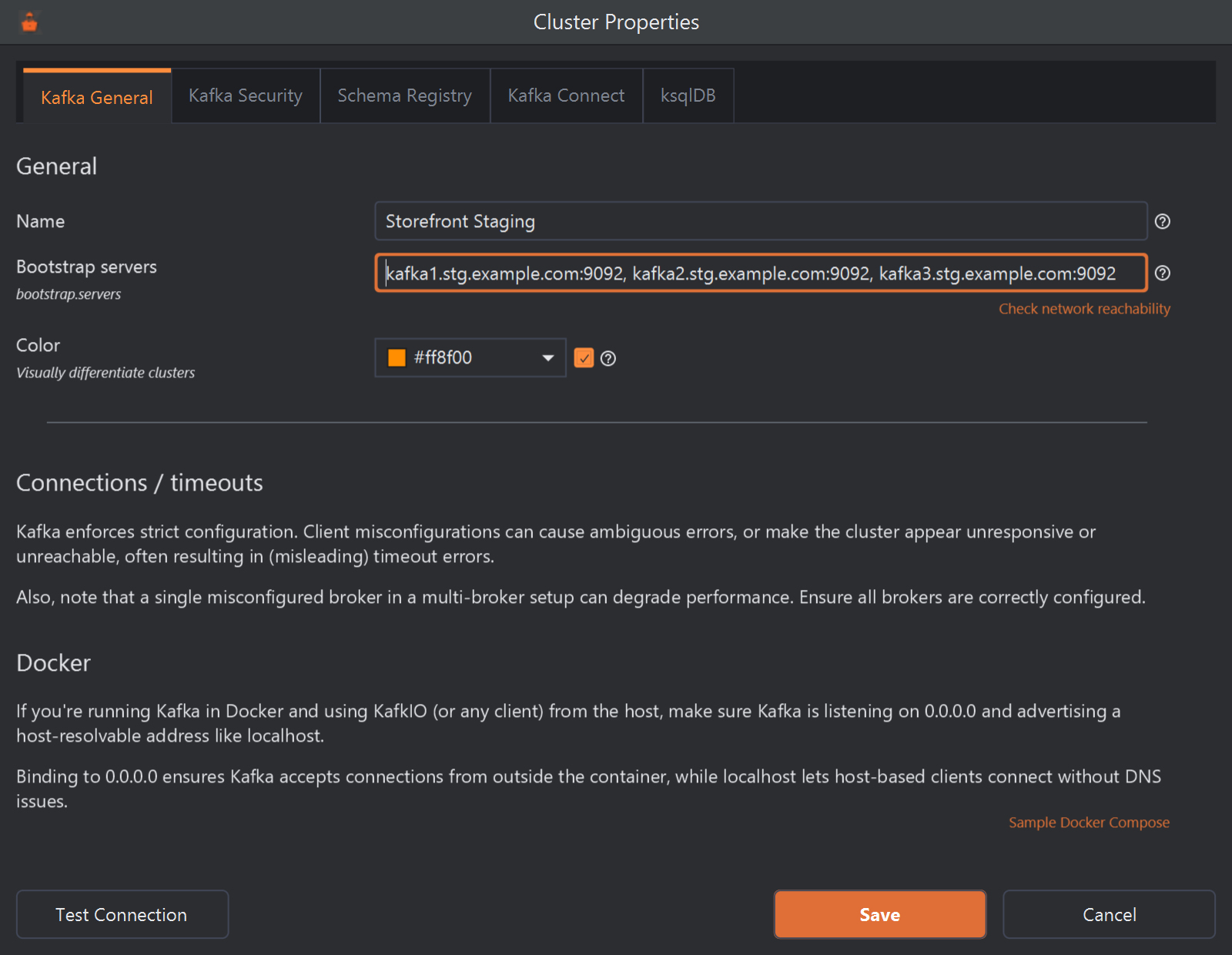 The Cluster Properties dialog on its Kafka General tab. Name is Storefront Staging; Bootstrap servers lists kafka1.stg.example.com:9092, kafka2.stg.example.com:9092 and kafka3.stg.example.com:9092, with a Check network reachability link under it; Color is ticked and set to amber, #ff8f00. Below are two notes, Connections / timeouts and Docker, the second with a Sample Docker Compose link, and at the bottom the Test Connection, Save and Cancel buttons.